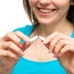 Young woman is breaking a cigarette, quit smoking concept, isola